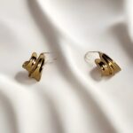 gold-tone chunky hoop earrings with a layered/wavy design - Image 4