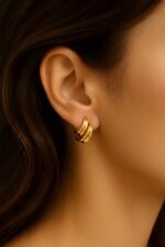 gold-tone chunky hoop earrings with a layered/wavy design - Image 3