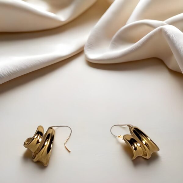gold-tone chunky hoop earrings with a layered/wavy design