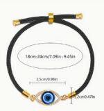 black adjustable bracelet with a blue evil eye  charm set in a gold-tone frame - Image 5
