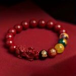 multi-color Feng Shui / spiritual beaded bracelet with red,  yellow, green, and clear beads along with carved dragon/Pi Xiu details - Image 4