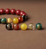 multi-color Feng Shui / spiritual beaded bracelet with red,  yellow, green, and clear beads along with carved dragon/Pi Xiu details - Image 6
